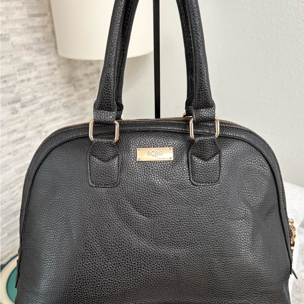 BCBG Paris black pebbled faux leather dome satchel handbag.